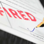 AI Push Results In 10% Job Cut Fountain pen signing document with the word fired