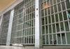 Cruise Cabin Horror: Judge Slams Cell Door Empty prison cell with metal bars and toilet.