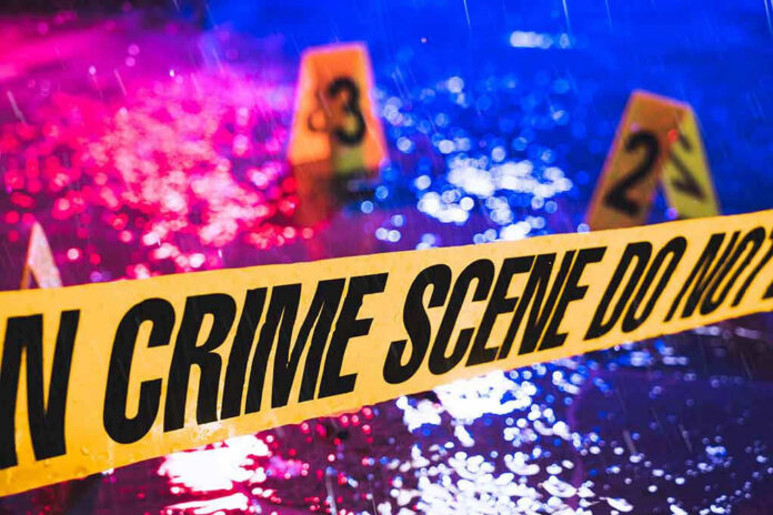 789623020 Crime scene tape with blurred evidence markers.