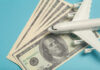 A model airplane placed on top of dollar bills