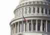 House GOP Rebels Challenge Trump In Key Vote U.S. Capitol dome with American flag flying.