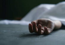VIDEO: Death Squad Strikes – 12 Dead Dead persons hand lying on a gray surface