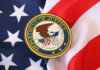 Mystery DOJ Probe Engulfs Lib Governor Department of Justice seal on American flag.