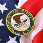 Mystery DOJ Probe Engulfs Lib Governor Department of Justice seal on American flag.