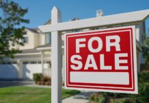 Congress vs Wall Street Homes A 'For Sale' sign in front of a house