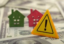 Mortgage Shocker: THIS Status Now Counts?! Colorful house models and a warning sign on dollar bills