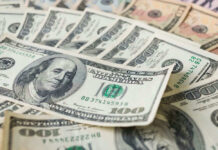 Fox’s $22B Power Grab Announced Stacks of various U.S. dollar bills.