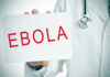 Ebola Alert: American Evacuated – BREAKING DETAILS! Doctor holding a sign about Ebola