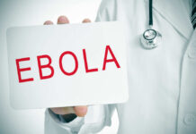 Ebola Alert: American Evacuated – BREAKING DETAILS! Doctor holding a sign about Ebola