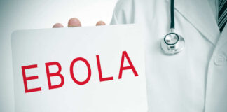 Doctor holding a sign about Ebola