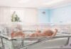 Billionaire Blast: $6.25B For Kids Newborn baby lying in a transparent crib in a hospital nursery
