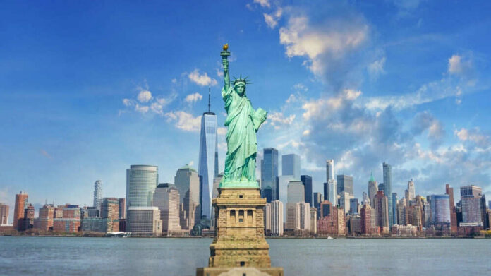 shutterstock_2436038841 Statue of Liberty with New York City skyline