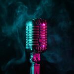 Beloved Music Icon’s Quiet Battle Stuns Fans A vintage microphone surrounded by colorful smoke