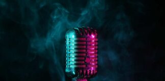 A vintage microphone surrounded by colorful smoke