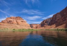 Power Cutoff Looms at Glen Canyon Red rock canyon with river under a bright blue sky