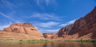 Red rock canyon with river under a bright blue sky