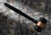 Judge Torches Trump’s Billion-Dollar IRS Deal Judge’s gavel on scattered US hundred-dollar bills
