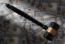 Judge Torches Trump’s Billion-Dollar IRS Deal Judge’s gavel on scattered US hundred-dollar bills