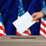 Shock Poll JOLTS Congress Hand casting a vote into a ballot box.