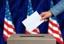 Shock Poll JOLTS Congress Hand casting a vote into a ballot box.