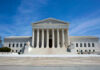 Supreme Court Alarm: Body Armor At Home U.S. Supreme Court building under clear blue sky.