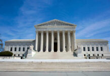 Supreme Court Alarm: Body Armor At Home U.S. Supreme Court building under clear blue sky.