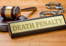 CONDEMNED: Death Sentence Handed Down Gavel handcuffs and death penalty sign on table