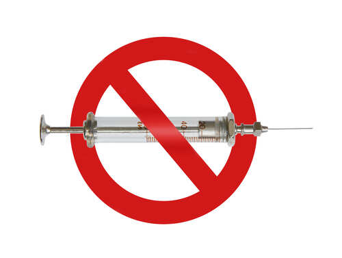 Sign,Drugs,Are,Forbidden,Isolated,On,A,White,Background. A syringe with a red prohibition sign overlay