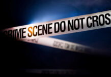 Teen Attacked With Sword, One Dead — Why? Police tape reading 'CRIME SCENE DO NOT CROSS' in a dark setting