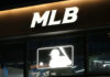 Illuminated MLB sign above storefront window
