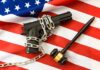 Tax Vanishes, Gun Rules Crumble A handgun chained on an American flag with a gavel beside it