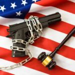 Tax Vanishes, Gun Rules Crumble A handgun chained on an American flag with a gavel beside it
