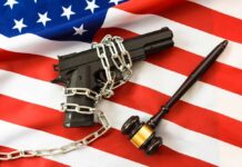 Tax Vanishes, Gun Rules Crumble A handgun chained on an American flag with a gavel beside it