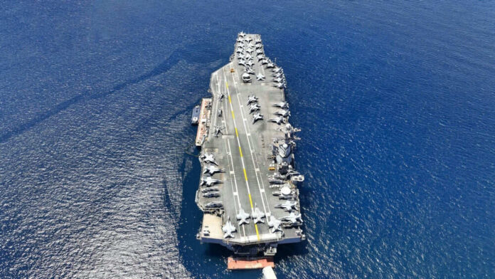 shutterstock_2354939185 Aircraft carrier on open sea with parked planes