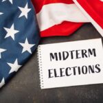 Musk’s Nine-Figure Midterm Gambit American flag and a notebook with 'MIDTERM ELECTIONS' written on it
