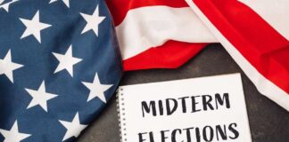 American flag and a notebook with 'MIDTERM ELECTIONS' written on it