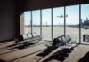 Heatwave Groundings Hit Major Hubs View of an airport waiting area with an airplane taking off in the background