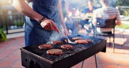 Barbecue,,Lunch,And,Man,With,Burgers,Outdoor,Backyard,For,Meal Person grilling burgers at an outdoor barbecue