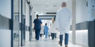 Medical staff walking through a hospital corridor