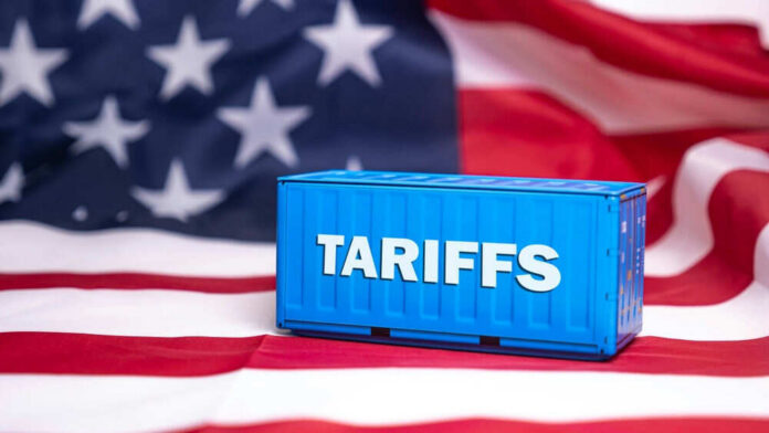 shutterstock_2593025849 Shipping container reading tariffs on the American flag