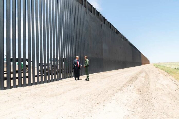 President,Donald,J.,Trump,Meets,U.s.,Border,Patrol,Chief,Rodney Group of people walking by a border fence.