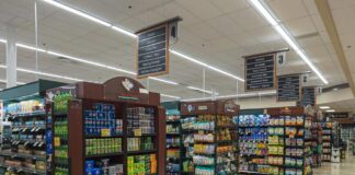 Interior view of a grocery store aisle with shelves of food and beverages