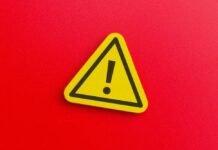 Yellow warning sign with exclamation mark on red background