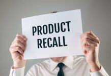 Amazon Yanks Mom Food Item Over Salmonella Scare Person holding a sign reading product recall