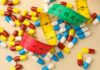 Weight-Loss Black Market Exposed Colorful capsules scattered with a measuring tape