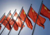 China-Backed Hackers Penetrate NASA, Fed, Senate Chinese flags waving under a clear sky.
