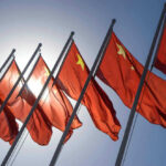 China-Backed Hackers Penetrate NASA, Fed, Senate Chinese flags waving under a clear sky.