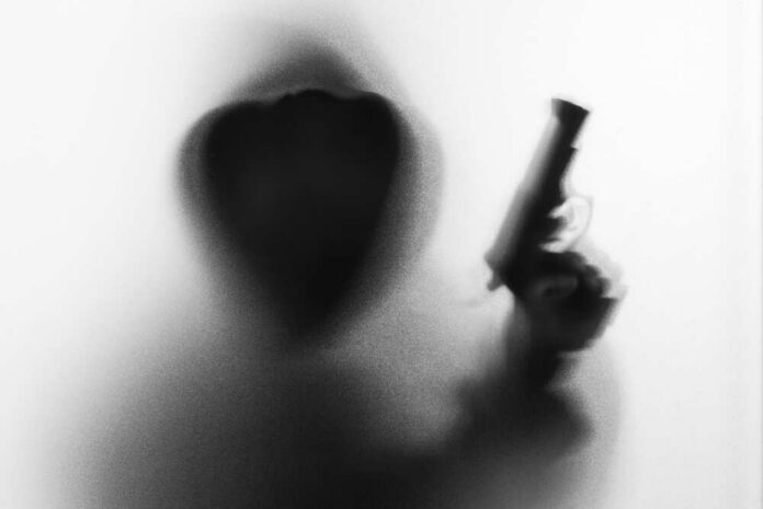 Shadow,Blur,Of,Horror,Man,In,Jacket,With,Hood,Gun Silhouetted hooded figure holding a handgun