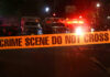 6 Dead: Murder Spree Leaves Town Reeling Crime scene tape with emergency vehicles in background.