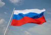 ALERT: Kremlin Hit Squad In D.C. Russian flag waving against a cloudy sky.